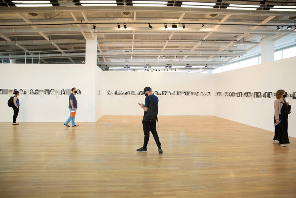 Instalación de exposición con fotografías en pared, en galería de arte.